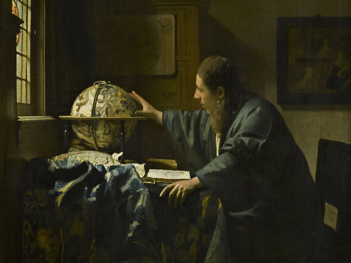 Vermeer's astronomer at his desk, one hand on a celestial globe