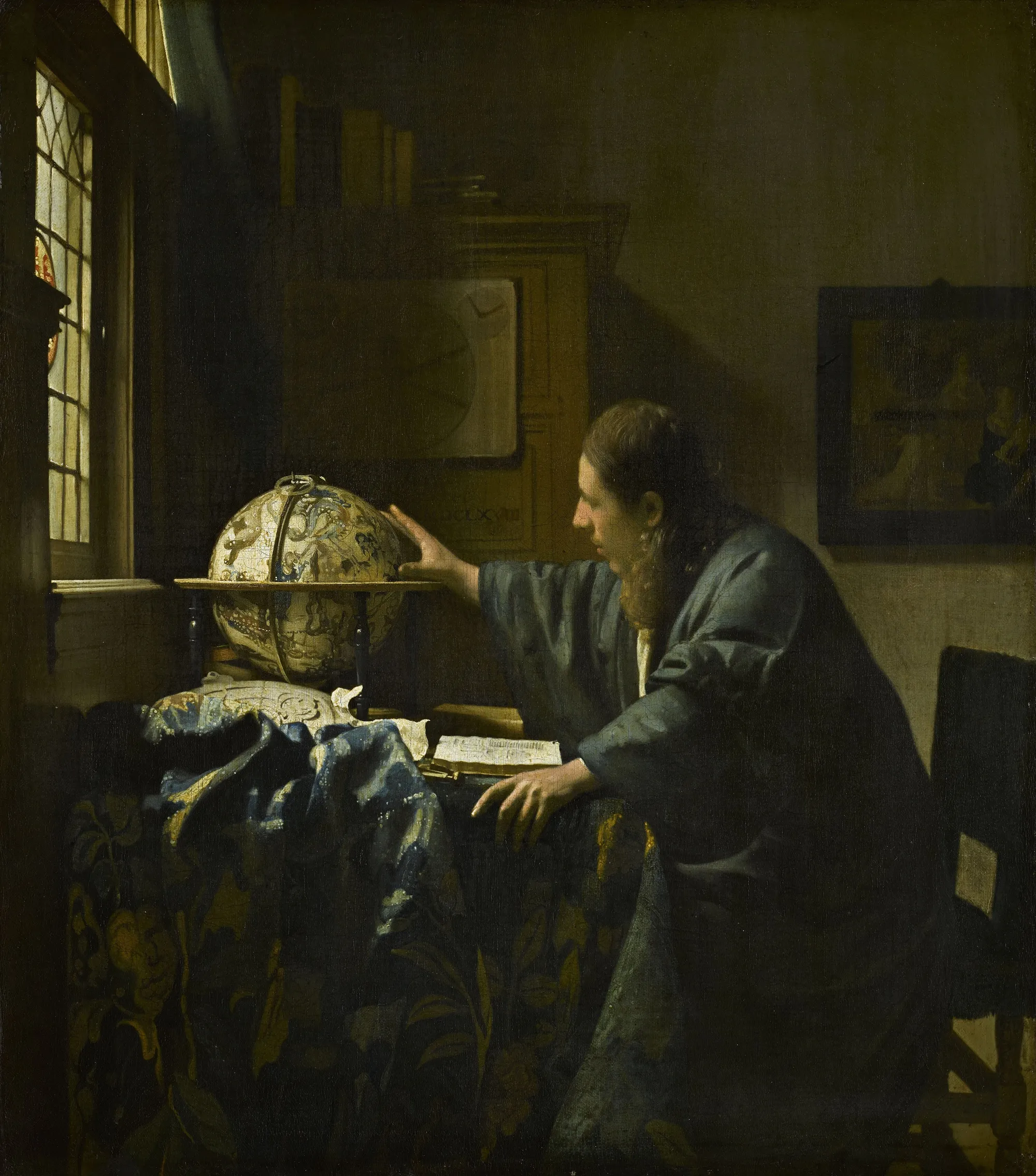 Vermeer's astronomer at his desk, one hand on a celestial globe