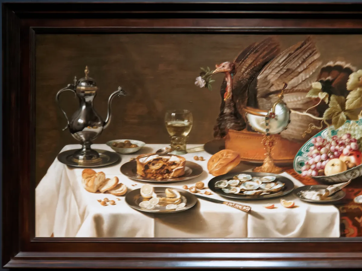 Pieter Claesz's laid table: turkey pie, silver, fruit and a half-peeled lemon