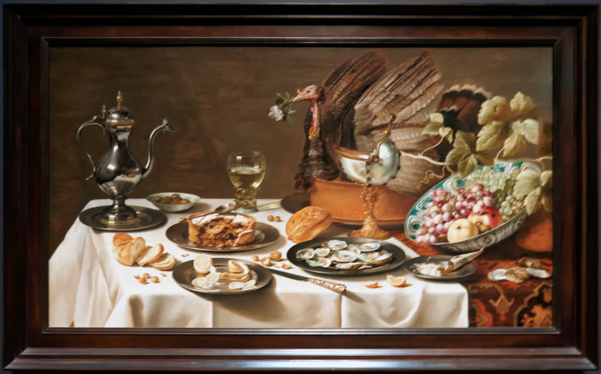 Pieter Claesz's laid table: turkey pie, silver, fruit and a half-peeled lemon